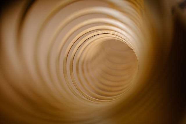 A view down the inside of a corrugated drainage pipe.