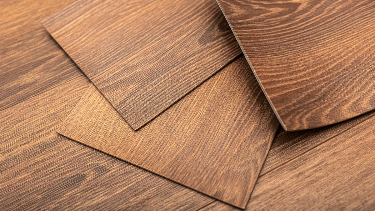 Close-up of reddish-brown wood-look planks with a pronounced grain texture, stacked and overlapping.
