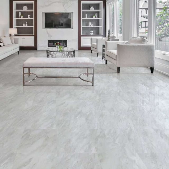 Pale grey marble-look flooring in a formal living room with white sofas, built-in shelving and a marble fireplace.