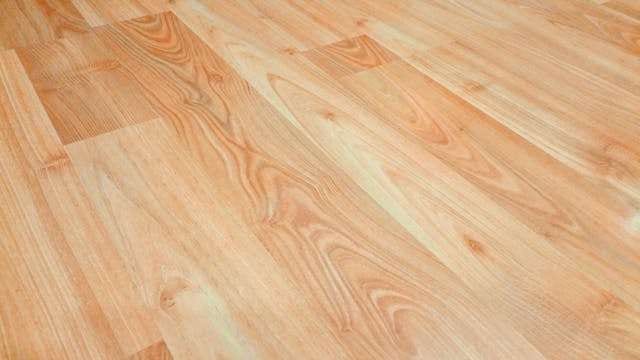 Close-up of honey-toned wood-look planks with strong grain.