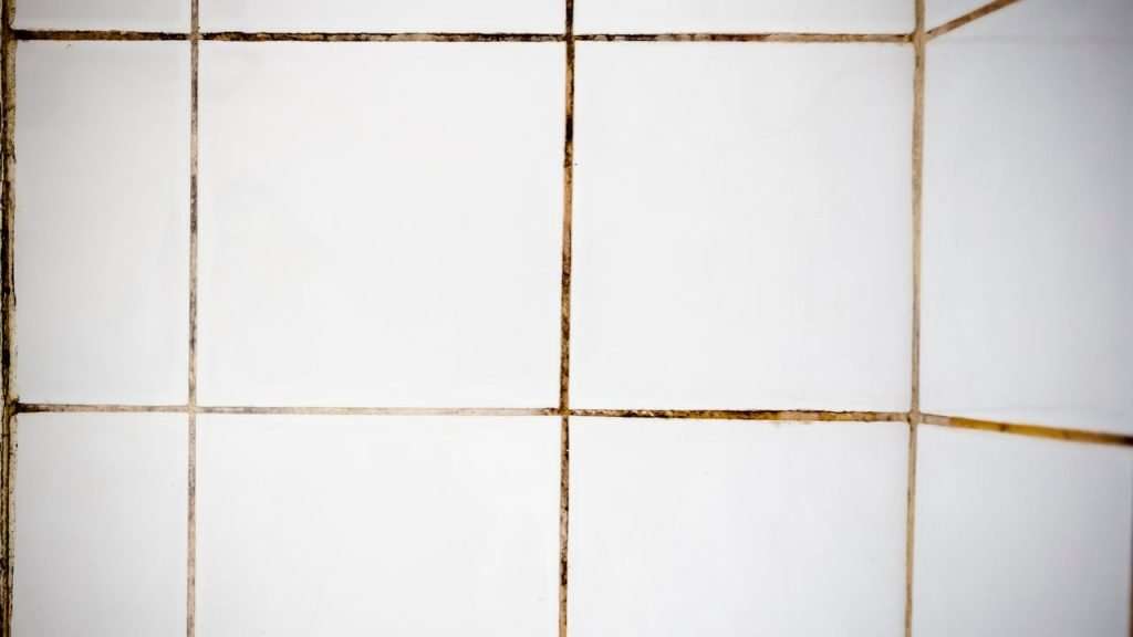 What are the side effects of chemical cleaners on grout?